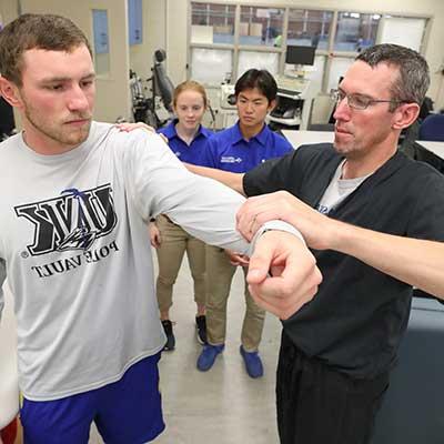 Athletic trainer working with students